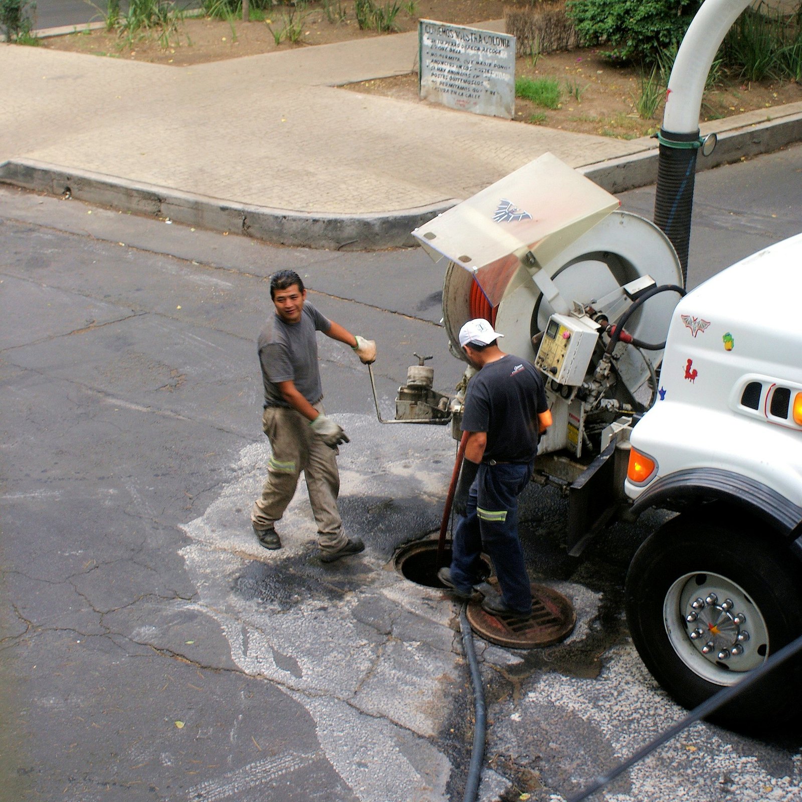 Sewer jetting truck cleaning a manhole