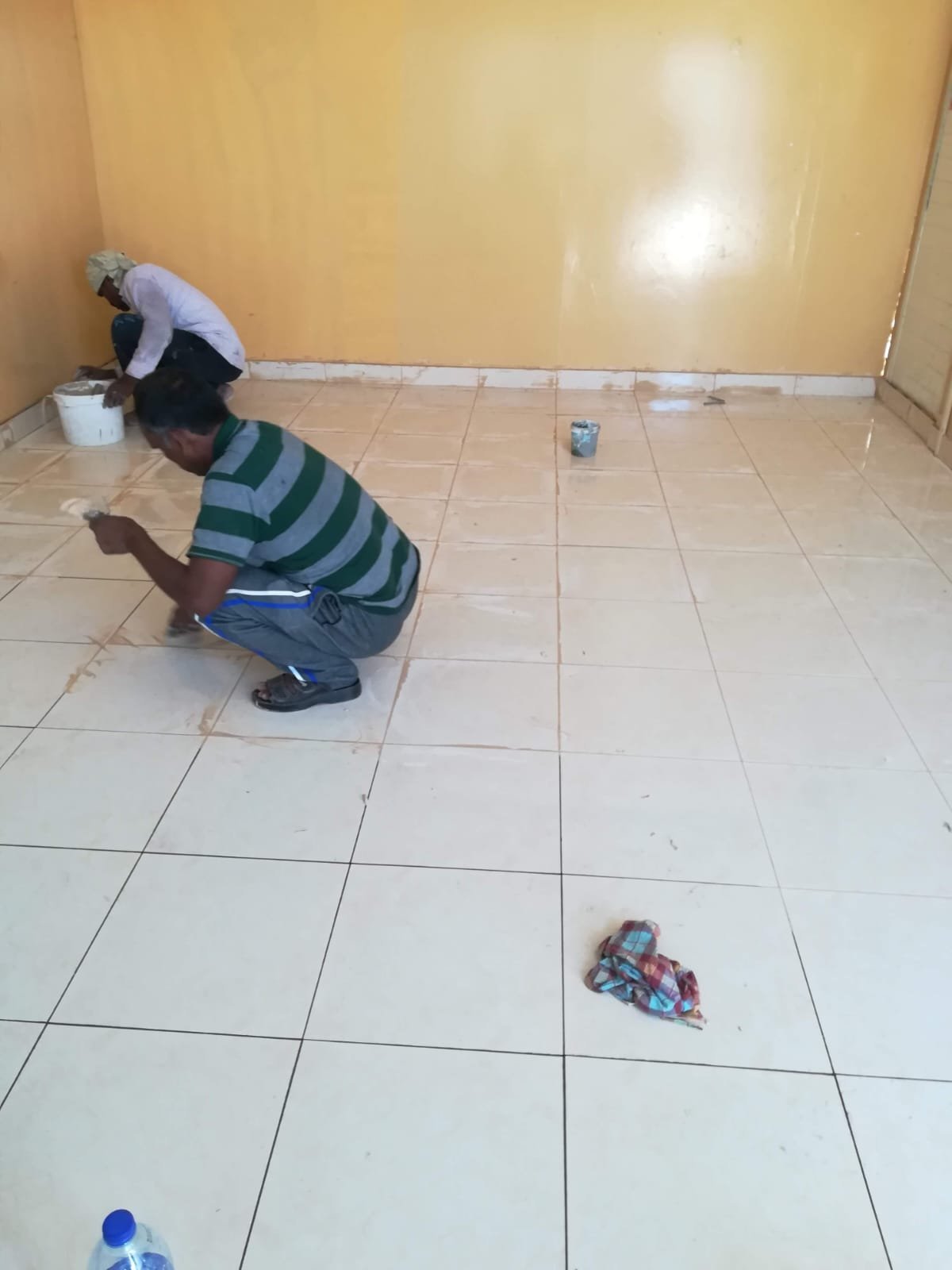 Tiler installing floor tiles in a Dubai apartment