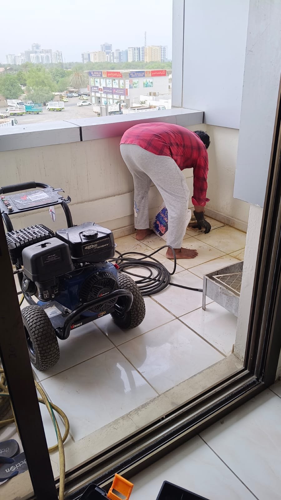 High-pressure drain cleaning equipment on a Dubai balcony