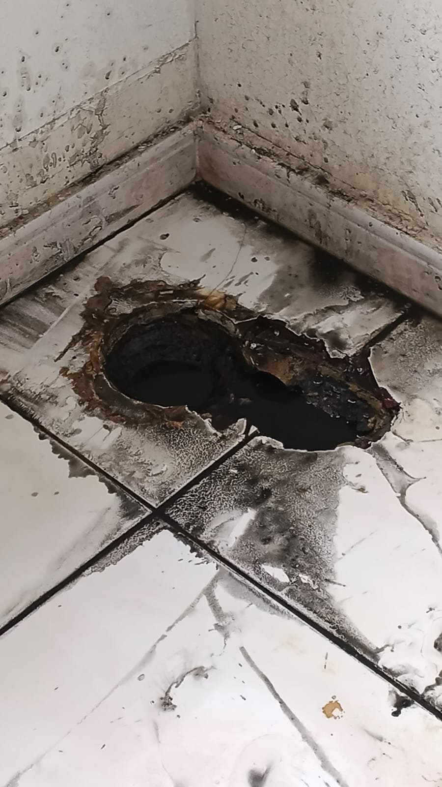 Manhole drain being cleared of blockage