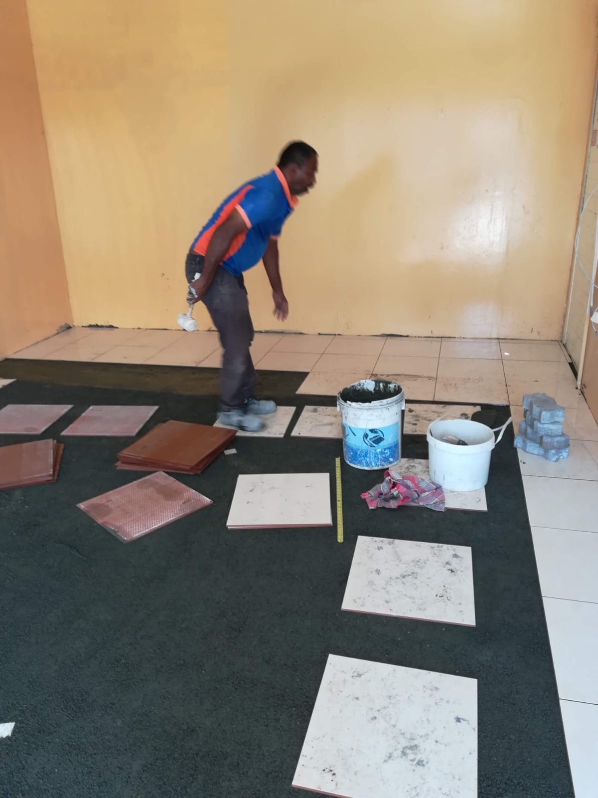 Worker laying out tile samples
