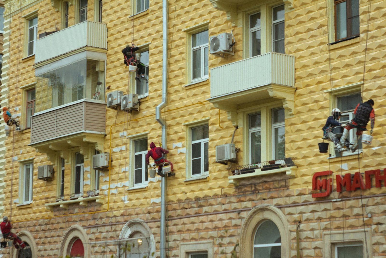 Rope-access workers maintaining a building facade